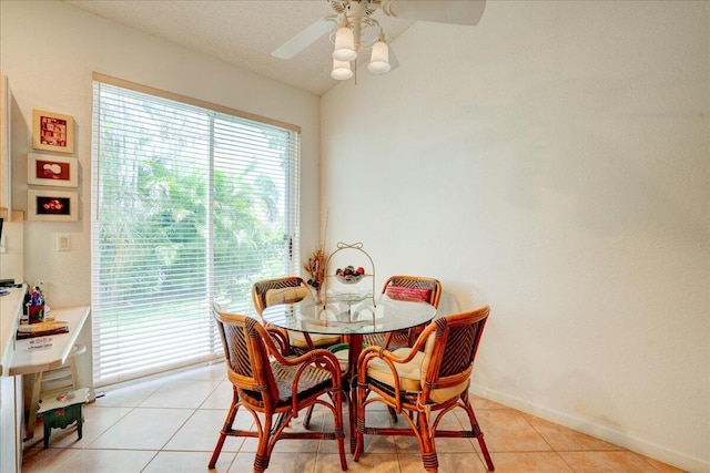 tiled dining space with ceiling fan