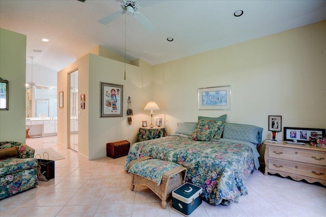 bedroom featuring ceiling fan, connected bathroom, vaulted ceiling, and light tile patterned floors