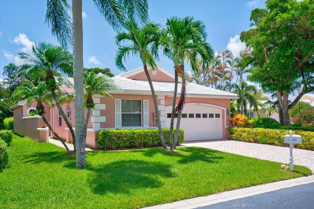 ranch-style house with a garage and a front yard