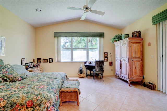 tiled bedroom featuring a textured ceiling, vaulted ceiling, and ceiling fan