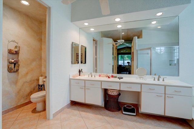 bathroom featuring dual vanity, ceiling fan, vaulted ceiling, and toilet