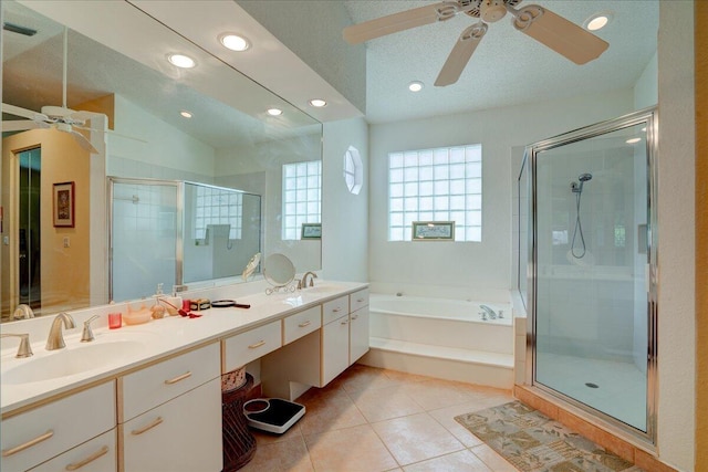 bathroom with tile patterned floors, ceiling fan, double sink vanity, separate shower and tub, and lofted ceiling