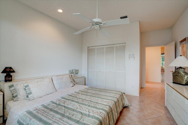 tiled bedroom with a closet and ceiling fan