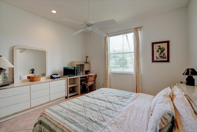 bedroom featuring light tile patterned flooring, a textured ceiling, and ceiling fan