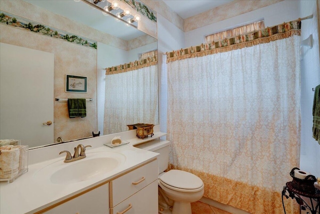 bathroom featuring tile patterned flooring, toilet, and vanity