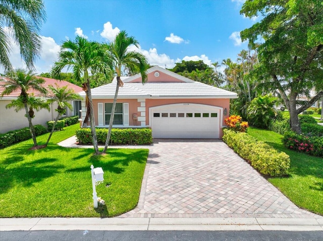 view of front facade with a garage and a front yard