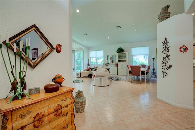 tiled entryway featuring lofted ceiling