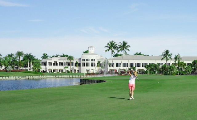 view of home's community featuring a water view and a lawn