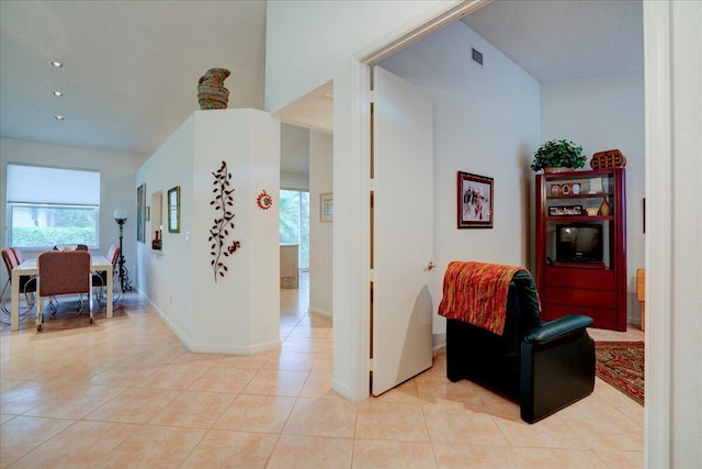 corridor featuring light tile patterned flooring