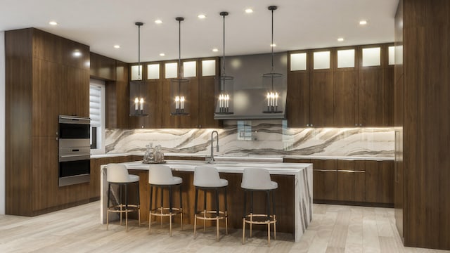 kitchen with light hardwood / wood-style floors, decorative light fixtures, a kitchen breakfast bar, a center island, and dark brown cabinetry