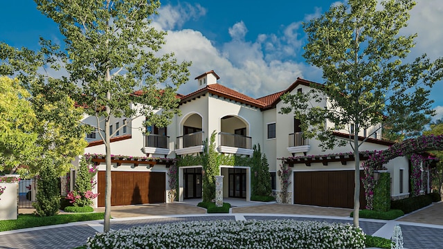 mediterranean / spanish house featuring a balcony and a garage