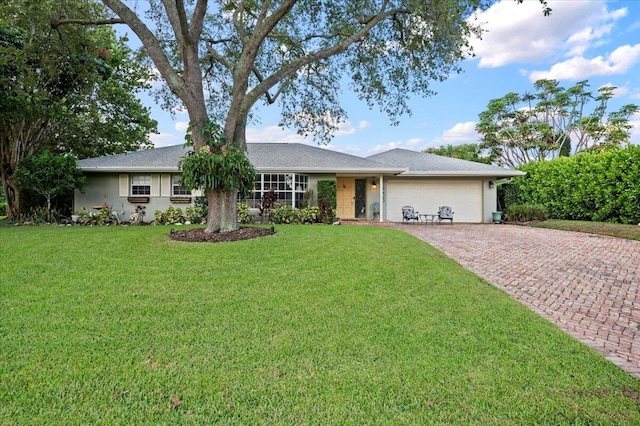 ranch-style home with a garage and a front yard