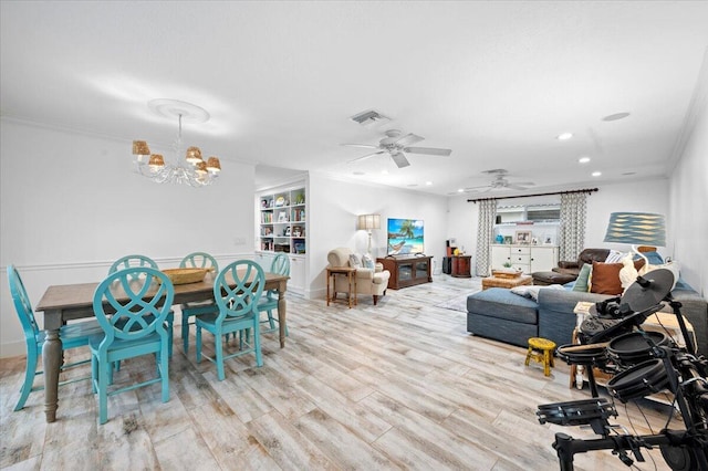 interior space featuring crown molding, light wood-type flooring, and ceiling fan with notable chandelier