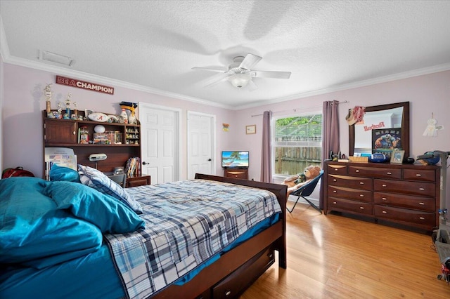 bedroom featuring ornamental molding, ceiling fan, light hardwood / wood-style floors, and a textured ceiling