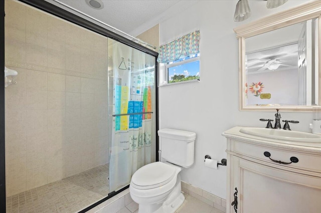 bathroom featuring walk in shower, crown molding, toilet, vanity, and ceiling fan