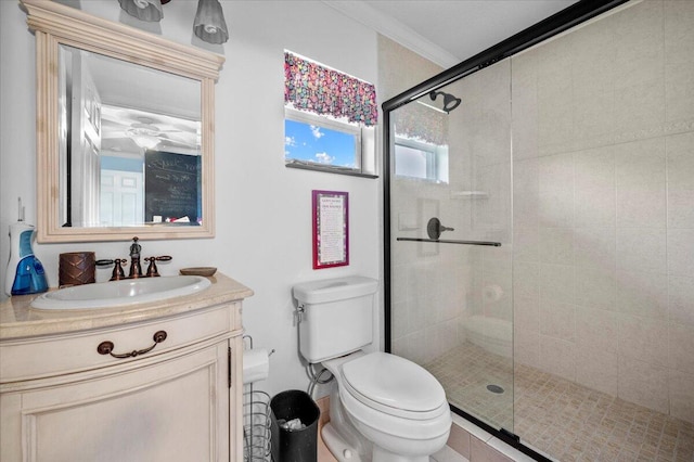 bathroom with vanity, walk in shower, ornamental molding, and toilet