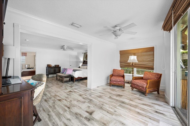 living room featuring light hardwood / wood-style floors, a textured ceiling, and ceiling fan