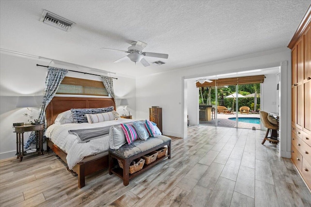 bedroom with access to exterior, light hardwood / wood-style flooring, a textured ceiling, and ceiling fan