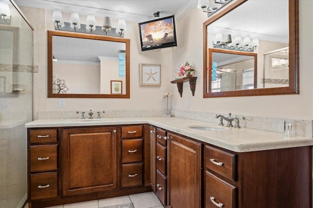 bathroom with tile patterned flooring, dual vanity, a textured ceiling, and ornamental molding