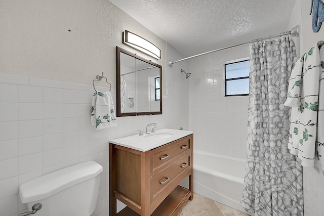 bathroom with shower / bath combo, toilet, a textured ceiling, vanity, and tile walls