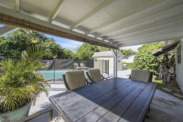 wooden deck with outdoor dining area, a fenced backyard, and a patio