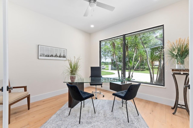 office area featuring ceiling fan, light hardwood / wood-style flooring, and a wealth of natural light