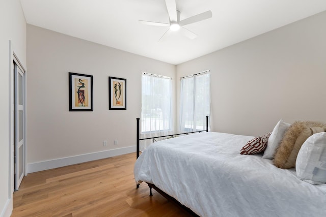 bedroom with light hardwood / wood-style floors and ceiling fan