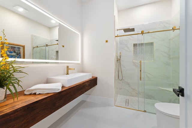 bathroom with walk in shower, tile patterned floors, toilet, and sink