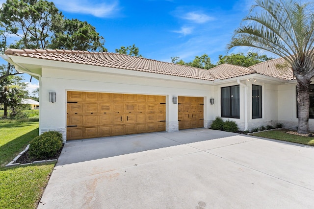 view of front of property featuring a garage and a front lawn