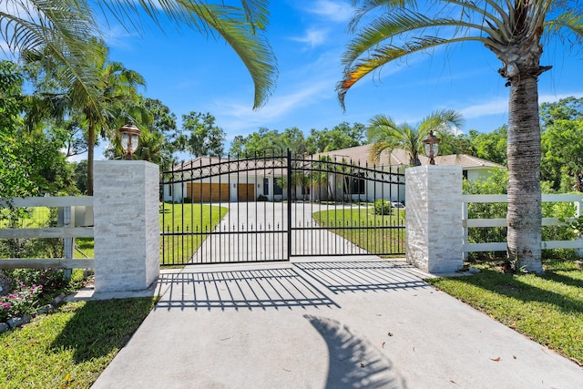 view of gate with a yard