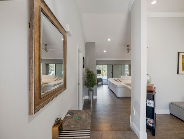 corridor featuring crown molding, dark tile patterned flooring, and a wealth of natural light