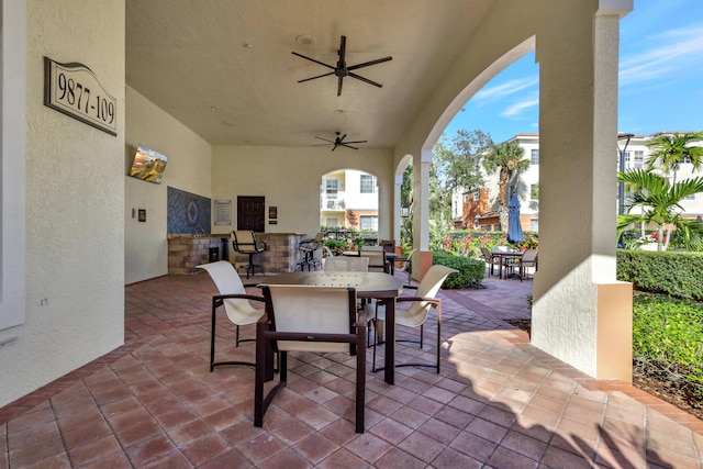 9873 Baywinds Dr Unit 5302, West Palm Beach, FL 33411 - view of patio / terrace featuring outdoor dining space, ceiling fan, and an outdoor kitchen