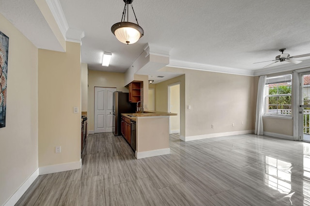 9873 Baywinds Dr Unit 5302, West Palm Beach, FL 33411 - kitchen with open floor plan, crown molding, baseboards, ceiling fan, and a textured ceiling