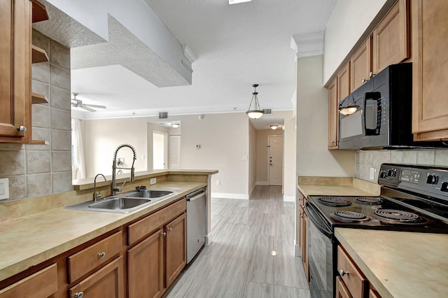 kitchen featuring sink, decorative backsplash, ceiling fan, hanging light fixtures, and black appliances