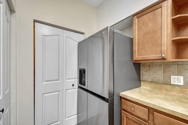 9873 Baywinds Dr Unit 5302, West Palm Beach, FL 33411 - kitchen featuring stainless steel fridge with ice dispenser, open shelves, backsplash, light countertops, and brown cabinetry