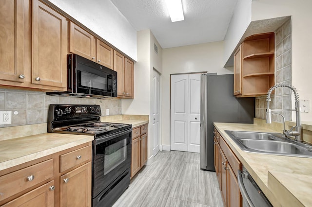 kitchen featuring backsplash, sink, a textured ceiling, light tile patterned floors, and black appliances