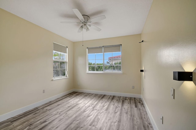 unfurnished room with ceiling fan and light hardwood / wood-style floors