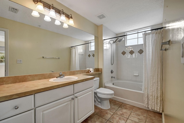 full bathroom featuring toilet, a textured ceiling, tile patterned flooring, vanity, and shower / tub combo