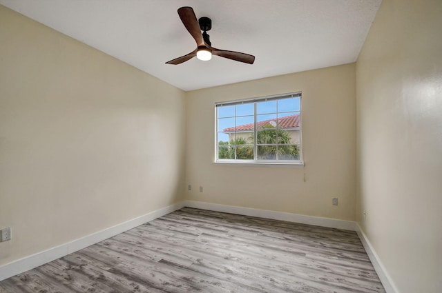 spare room with ceiling fan and light hardwood / wood-style flooring