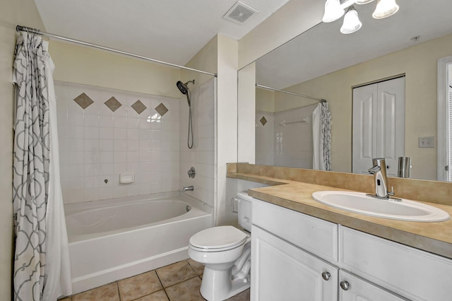 full bathroom with tile patterned flooring, toilet, vanity, and shower / bath combo with shower curtain