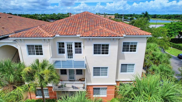 rear view of property with a balcony