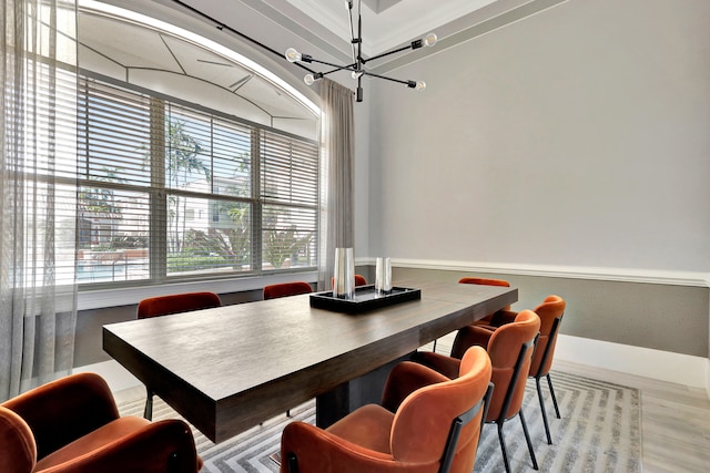 dining space with hardwood / wood-style flooring and an inviting chandelier