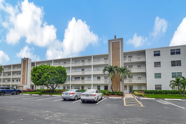 view of building exterior featuring uncovered parking