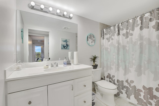 bathroom featuring tile patterned flooring, toilet, and vanity