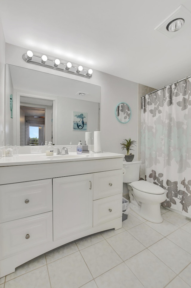 bathroom featuring tile patterned floors, vanity, and toilet