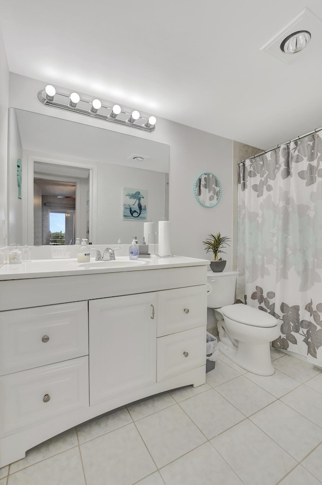 bathroom featuring vanity, tile patterned flooring, toilet, and a shower with curtain