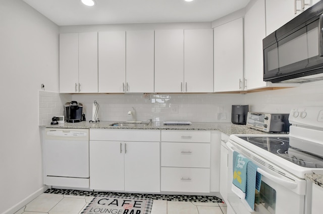 kitchen with white appliances, a toaster, a sink, light stone countertops, and backsplash