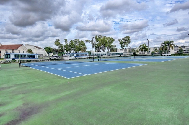 view of tennis court featuring fence