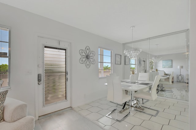 dining room featuring a chandelier and light tile patterned floors