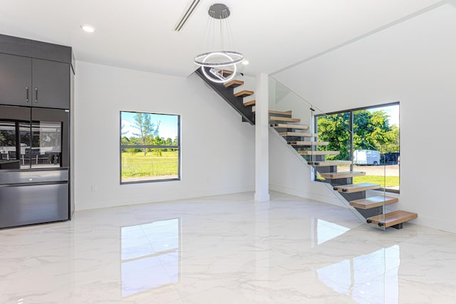 interior space with marble finish floor, stairs, baseboards, and recessed lighting